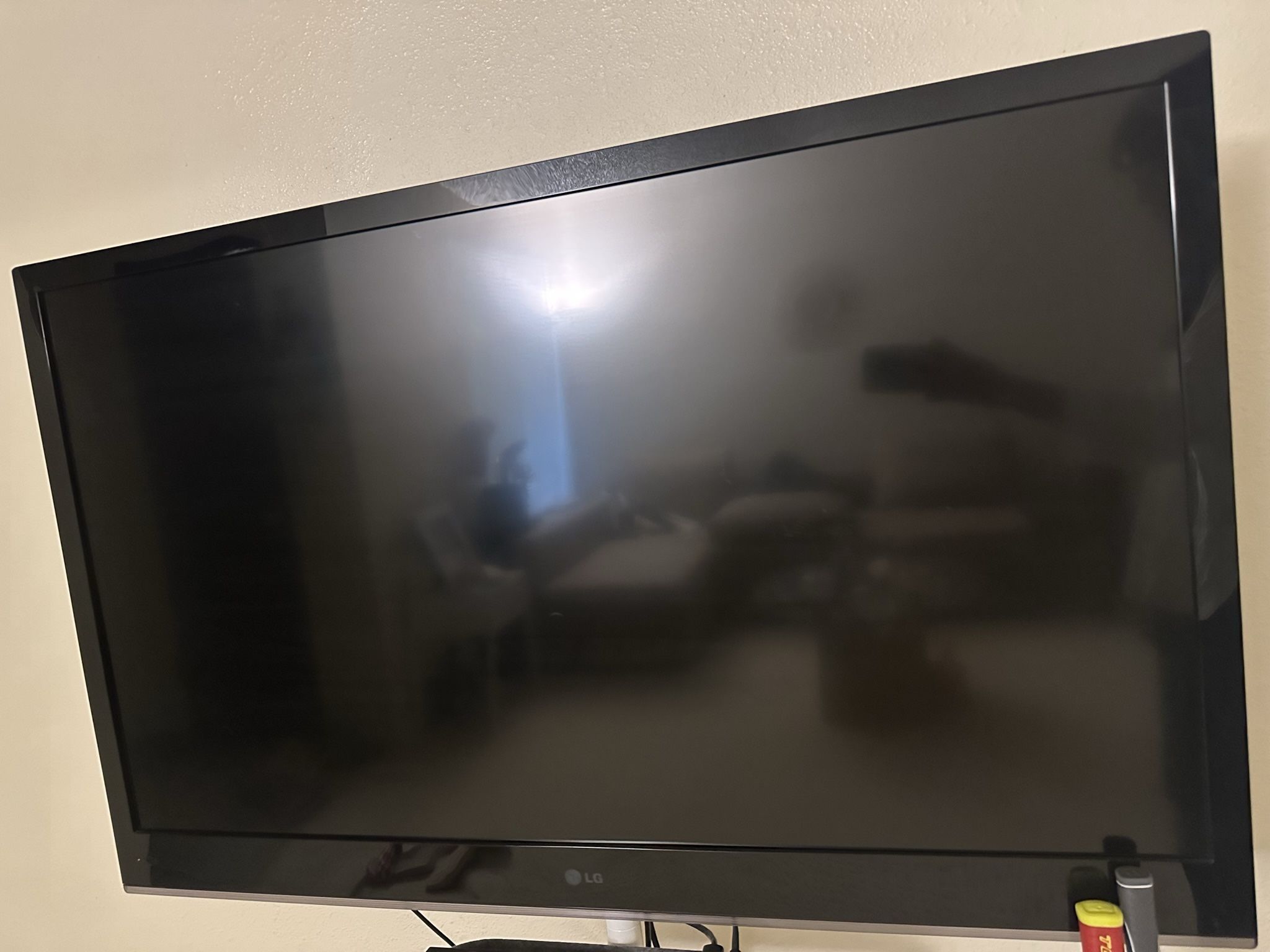 LG TV with modern TV Stand + Apple TV 