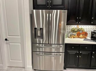 Stainless steel Samsung refrigerator has a 4-door French door
