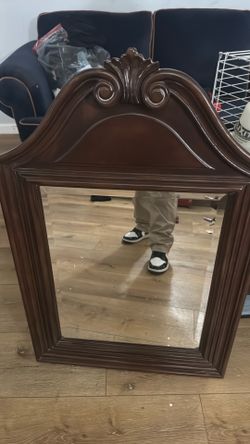 $125 Vintage carved cherry This is a traditional carved cherry wood pediment beveled wall mirror featuring a scrolled scrolltop accent and fluted fram
