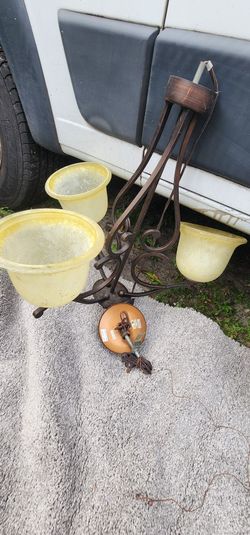 oil-rubbed bronze chandelier with frosted white glass shades. 