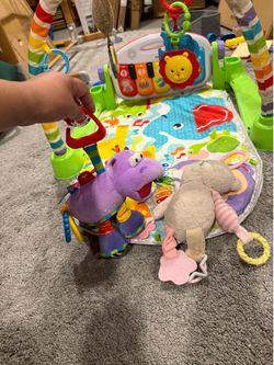 Fisher-Price Deluxe Kick & Play Piano Gym in green, featuring a playmat, toy arch, and detachable musical keyboard. Baby toys