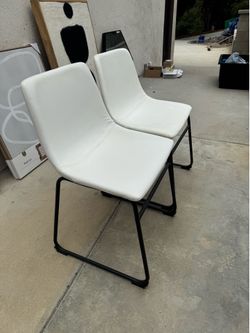 Set of two modern white leather chairs