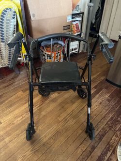 Black metal rolling walker