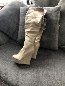 Thigh high wedge platform boots. They string up the back. Very sexy. Size 8