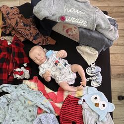 Realistic reborn baby doll with clothing bundle