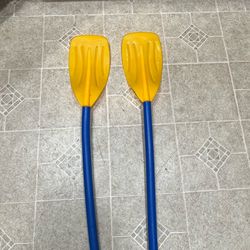 Pair of yellow and blue boat paddles