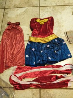 Women's Wonder Woman Costume. Missing the Headpiece. The cape is faded. Size small. Dress, cape, belt, boot covers and wrist covers.