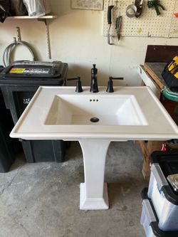 White Pedestal Sink with fixtures