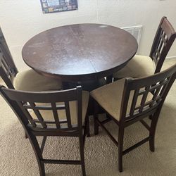 Adjustable Teakwood dining table with 4 chairs.