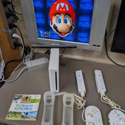 White Nintendo Wii with 2 remotes, classic controllers Wii sports also has Mario 64 loaded on system