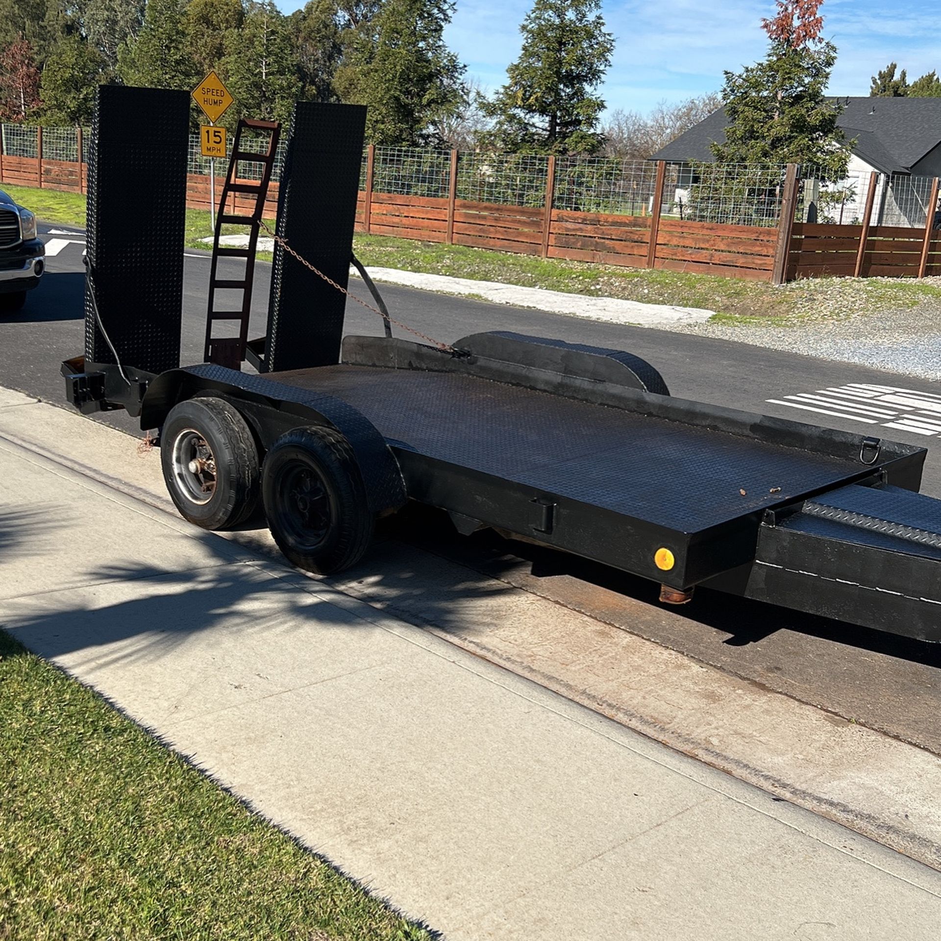 Knutson Trailer heavy duty for backhoe, a bobcat, diamond plate, all around 14 foot bed, but heavy duty ramps