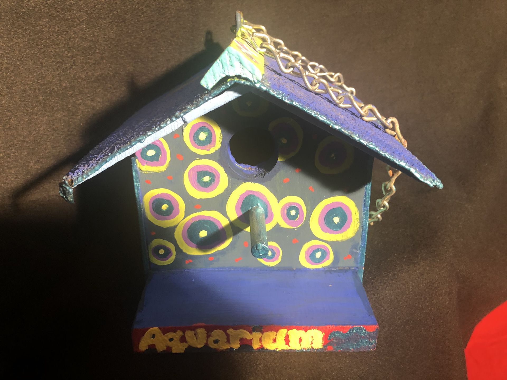 The Aquarium bird house. Bright colors, hand painted, hangs by a chain