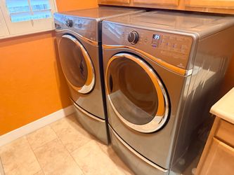 Whirlpool electric Washer And Dryer with pedestals.