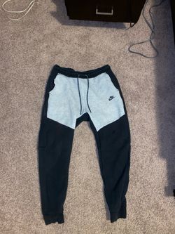 Black and grey Nike tech sweatpants