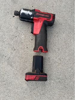Snap-on CT761A 14.4V 3/8" cordless impact wrench. It features a compact design with a variable-speed paddle trigger and LED work lights. It comes with