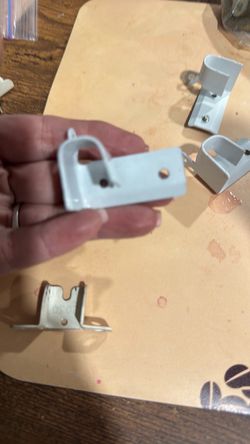 L-Shaped Drop-in Socket Bracket & basic metal curtain rod bracket.Specifically, this is the mounting hardware used to support the central or end secti