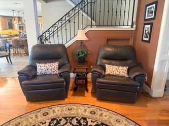 2 brown leather rocking recliners