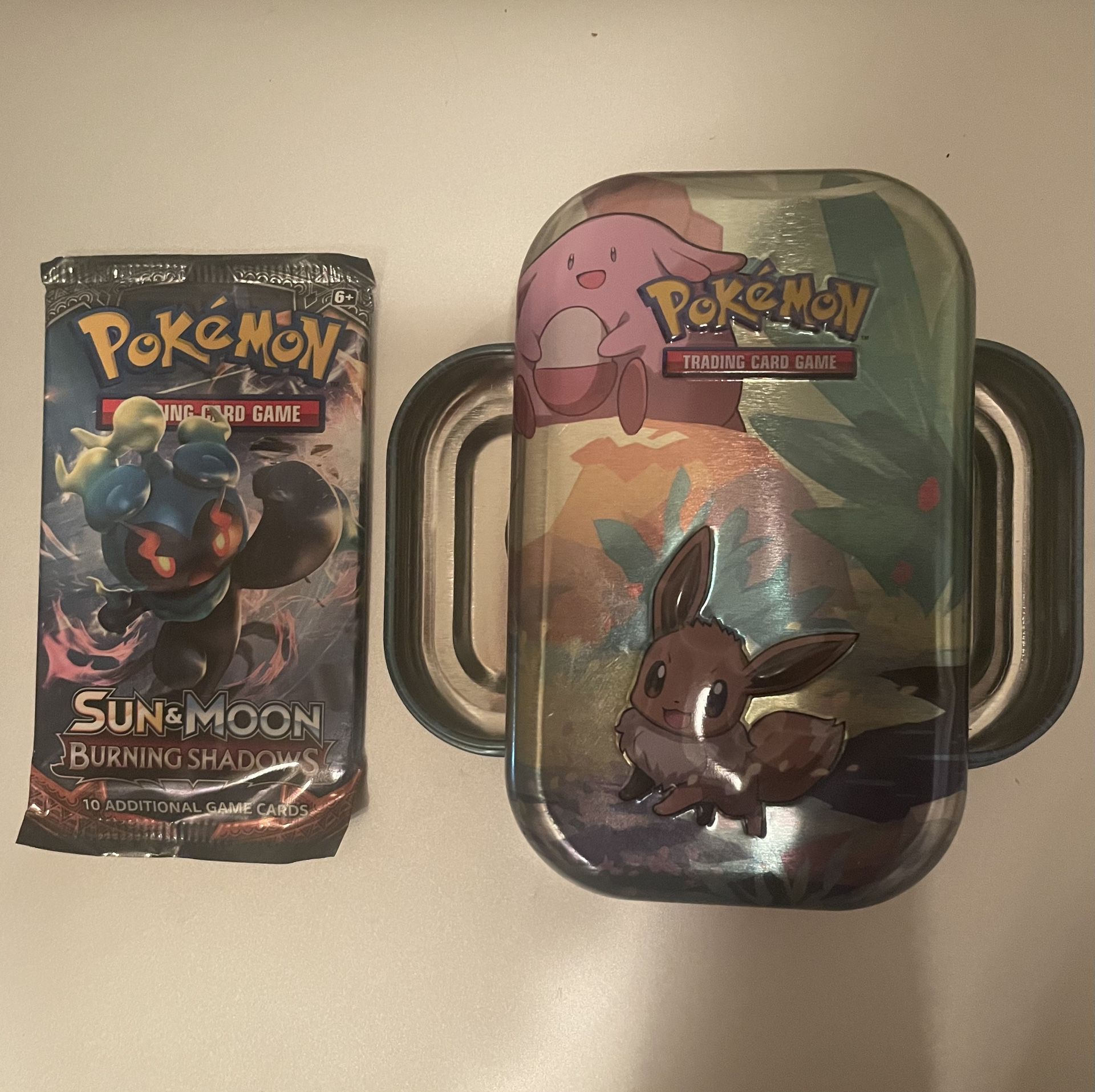 Sealed 2017 Pokémon TCG Sun & Moon Burning Shadows Booster Pack PLUS an empty Pokemon Galar Tins - all in great condition. PSA 10 Charizard?