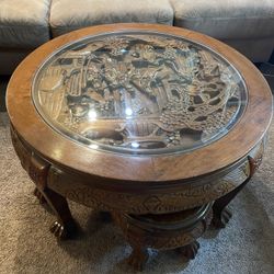 Vintage Chinese Massive Round Carved Coffee Table w/4 Nesting Stools  Glass has a scratch and one of the chairs has damage to the seat.