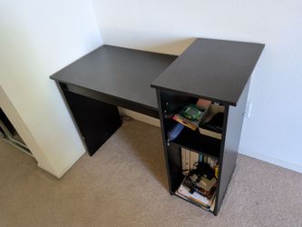 Black L shaped desk with shelves