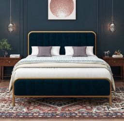 Beautiful queen-size upholstered bed frame in deep blue velvet with a gold-tone metal frame.