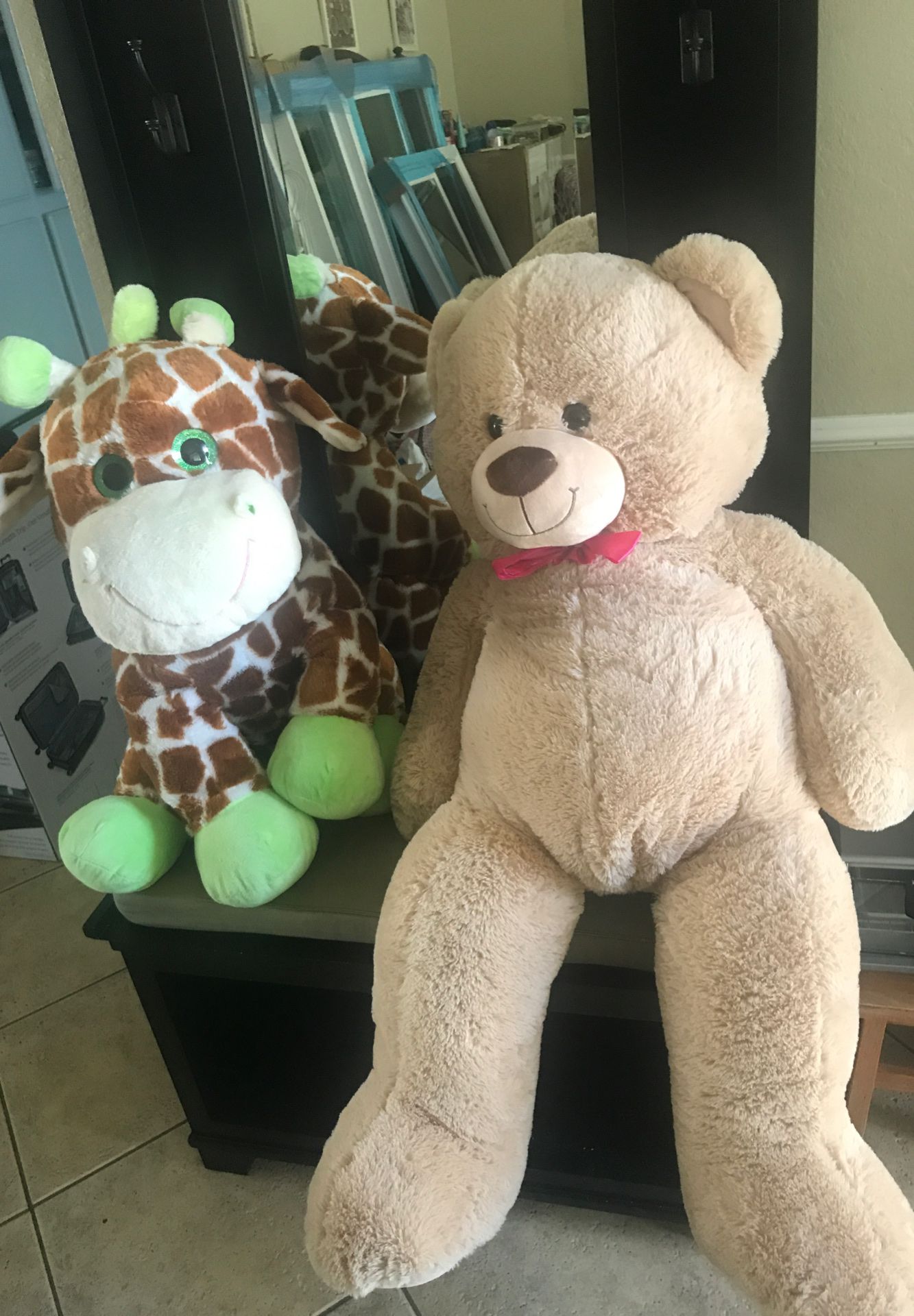 Big teddy bear and giraffe stuffed animals