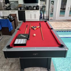 Pool table.This perfect pool table comes with 16 billiard balls and 3 wooden dowels.I can deliver for an additional cost