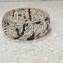 Bangle bracelet Indonesian, clear acrylic or resin base with a batik-inspired design