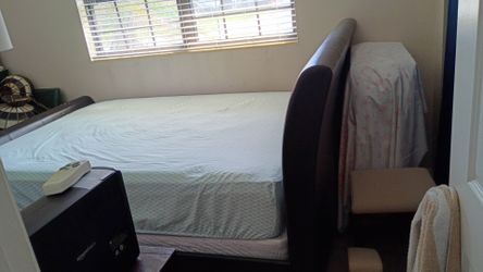 Selling a complete Queen Sized Bed,boxspring & mattress ,wood & leather head& footboard.goid condition