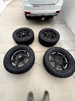 Off road tires with rims 90% . With 20 inch wheels. OBO