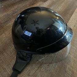 preowned glossy black half-shell motorcycle helmet with a drop-down sun visor