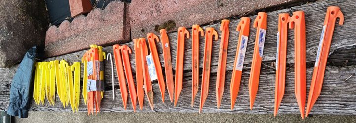 36 USED HARD PLASTIC TENT STAKES + 1 TENT STAKES BAG