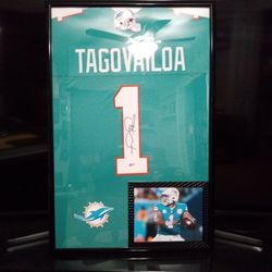 TUA TAGOVAILOA, WITH THE MIAMI DOLPHINS, STITCHED, SIGNED FRAMED JERSEY WITH COA.