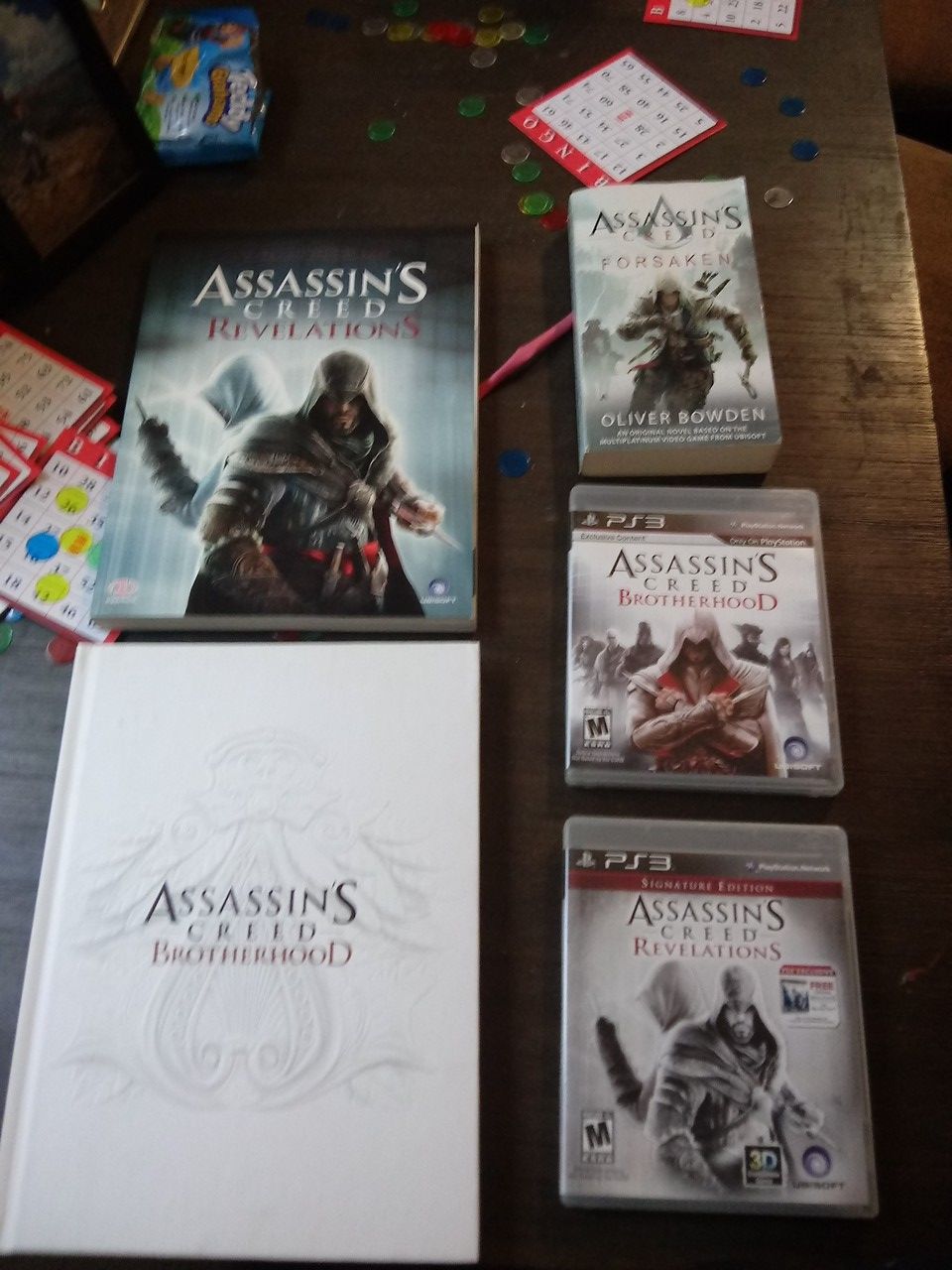 Assassin's Creed, ps3 game not scratched, complete game booksb and a reading book by Oliver Bowden