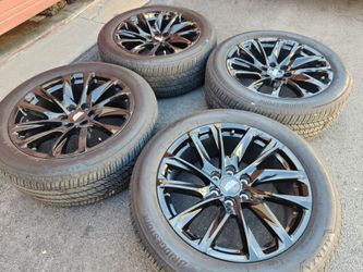 22" Cadillac Escalade black factory wheels and tires
