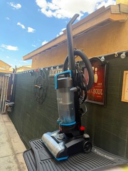 BISSELL PowerForce Compact Bagless Upright Vacuum, featuring a lightweight black and blue housing with a clear dirt cup.