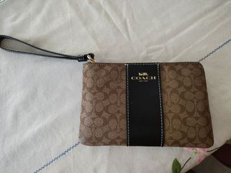 Coach Wristlet. Never used. Not sure if authentic but papers inside. Almost like the previous one posted. Still has paper inside. Great Xmas gift. No 
