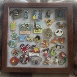 Lot of 32 Disney pins with glass display case