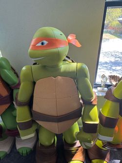 48-inch (4-foot) JAKKS Pacific Colossal Teenage Mutant Ninja Turtles Michelangelo action figure based on the 2012 animated series, featuring an orange