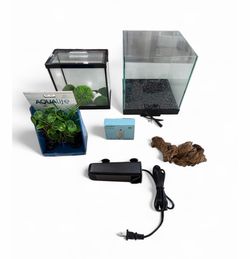 Aquarium set with 2 tanks, pump, filter, and decorations. Sold as is . Might be missing parts.