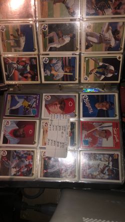 Binder full of mixed baseball cards with Pokémon cards