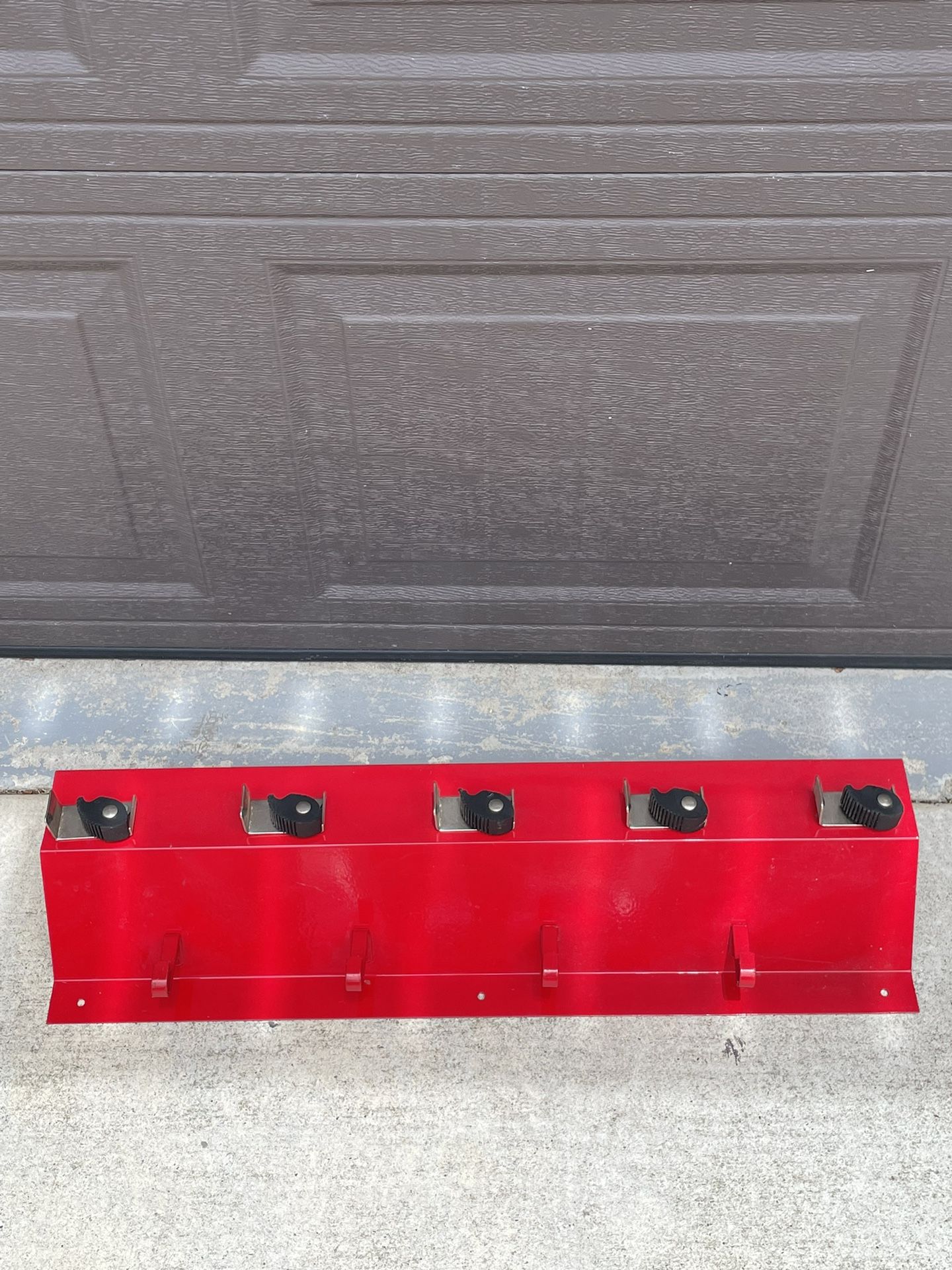 Red metal wall broom rack with shelf