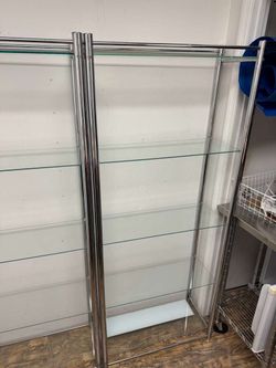 Two modern chrome and glass shelving units