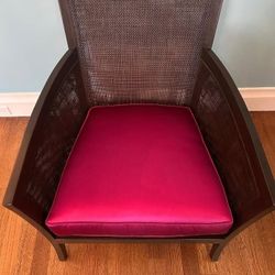 dark brown caned occasional chair with custom raspberry silk cushion
