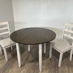 Round wood table with 2 chairs. Fold down sides