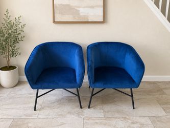 Beautiful set of two brand new blue velvet accent chairs with black metal legs.