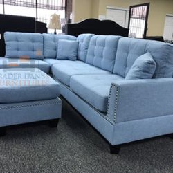 light blue linen sectional sofa with Ottoman and 2 accent pillows.
