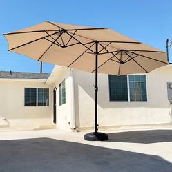 $130 (New in Box) Large 15 ft double sided outdoor umbrella with 65 lbs plastic weight base (beige color)