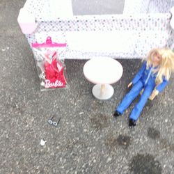 A Little Kid's Baby Bed For Doll Plus A Barbie Doll And A Table With Chair And A Bobby Leash
