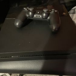 playstation 4 with controller and wires